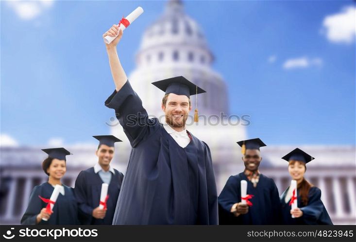education, graduation and people concept - group of happy international students in mortar boards and bachelor gowns with diplomas over american white house background