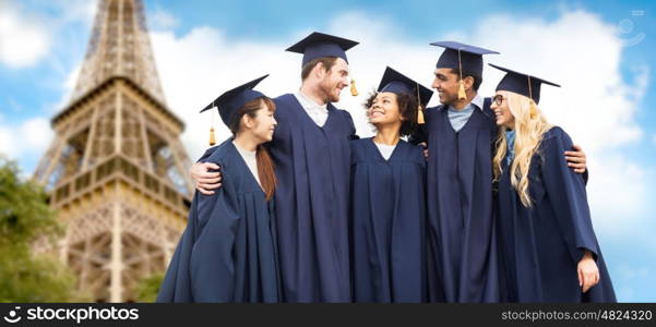 education, graduation and people concept - group of happy international students in mortar boards and bachelor gowns over eiffel tower background