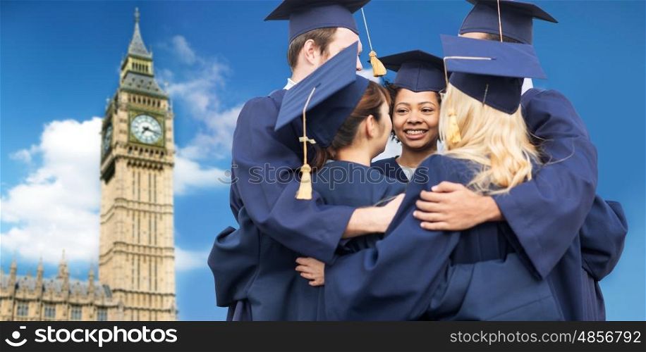 education, graduation and people concept - group of happy international students in mortar boards and bachelor gowns hugging over big ben clock tower in london city background