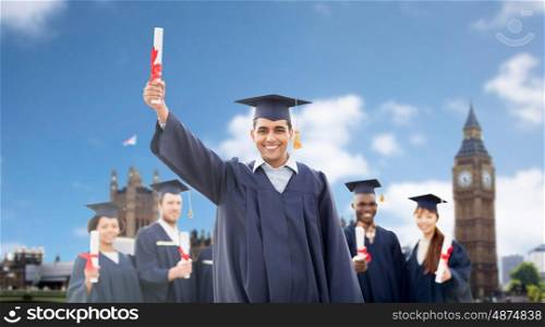 education, graduation and people concept - group of happy international students in mortarboards and bachelor gowns with diplomas over london background