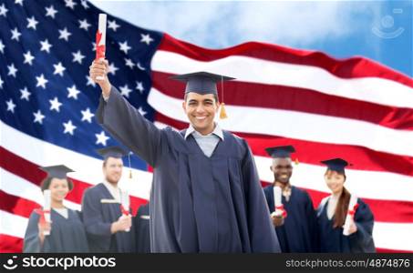 education, graduation and people concept - group of happy international students in mortarboards and bachelor gowns with diplomas over american flag background