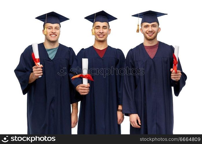 education, graduation and people concept - group of happy male graduate students in mortar boards and bachelor gowns with diplomas over white background. male graduates in mortar boards with diplomas