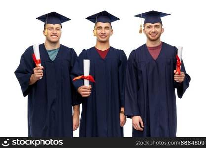 education, graduation and people concept - group of happy male graduate students in mortar boards and bachelor gowns with diplomas over white background. male graduates in mortar boards with diplomas