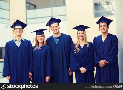 education, graduation and people concept - group of smiling students in mortarboards and gowns outdoors