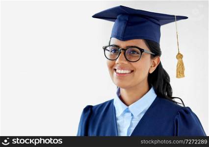 education, graduation and people concept - happy female graduate student in mortarboard and bachelor gown. happy female graduate student in mortarboard