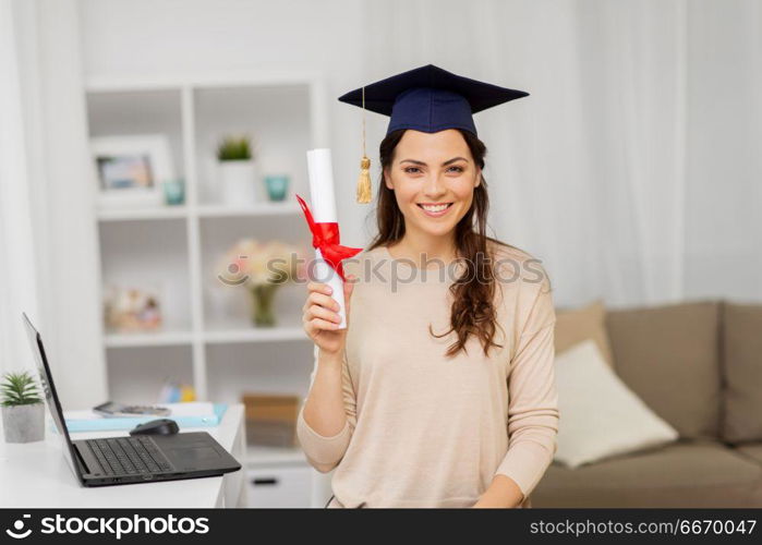 education, graduation and people concept - happy female student with diploma at home. happy female student with diploma at home. happy female student with diploma at home
