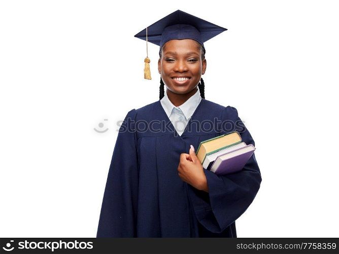 education, graduation and people concept - happy graduate student woman in mortarboard and bachelor gown with books over white background. happy female graduate student with books