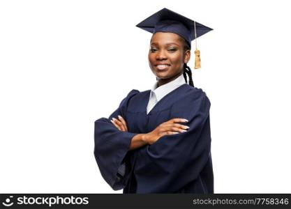 education, graduation and people concept - happy graduate student woman in mortarboard and bachelor gown. happy female graduate student in mortarboard