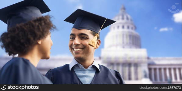 education, graduation and people concept - happy international students in mortar boards and bachelor gowns over american white house background