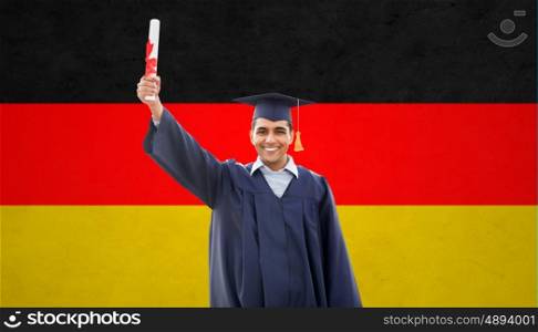 education, graduation and people concept - happy male student in mortarboard and bachelor gown with diploma over german flag background
