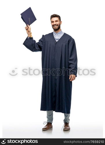 education, graduation and people concept - happy smiling male graduate student with mortar board and bachelor gown over white background. graduate student in bachelor gown with mortarboard