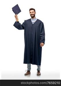 education, graduation and people concept - happy smiling male graduate student with mortar board and bachelor gown over white background. graduate student in bachelor gown with mortarboard