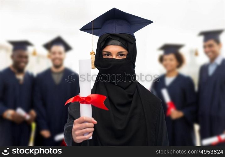 education, graduation and people concept - muslim student woman in hijab with diploma over group of bachelors on background. muslim student woman in hijab with diploma