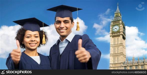education, graduation, gesture and people concept - happy international students in mortar boards and bachelor gowns showing thumbs up over big ben clock tower in london city background