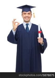 education, graduation, gesture and people concept - smiling adult student in mortarboard with diploma showing ok hand sign
