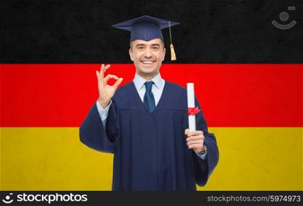 education, graduation, gesture and people concept - smiling adult student in mortarboard with diploma showing ok hand sign over german flag background