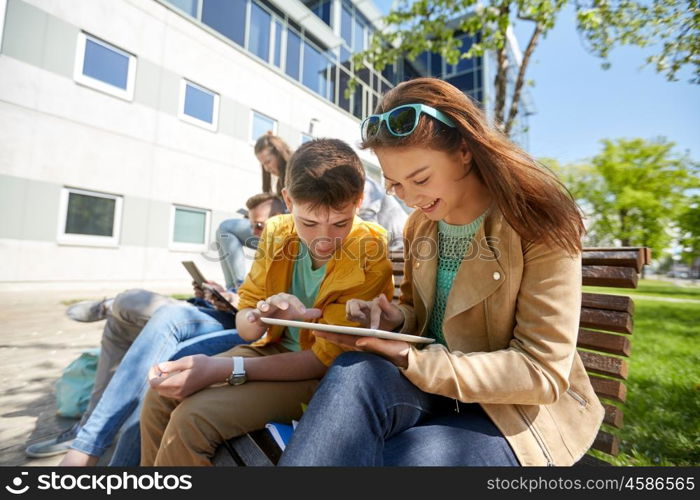 education, high school and people concept - group of happy teenage students with tablet pc computers at campus yard