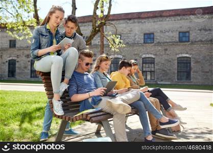 education, high school and people concept - group of happy teenage students with tablet pc computers at campus yard