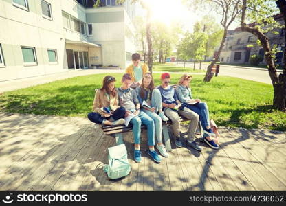 education, high school and people concept - group of happy teenage students with notebooks learning at campus yard. group of students with notebooks at school yard. group of students with notebooks at school yard