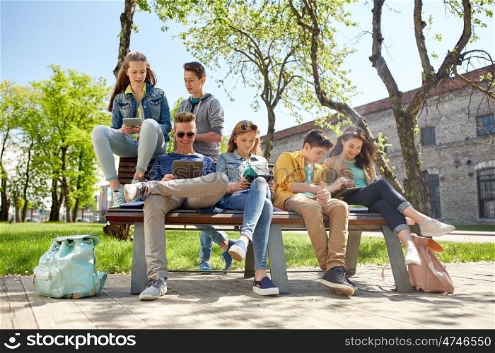 education, high school and people concept - group of happy teenage students with tablet pc computers at campus yard