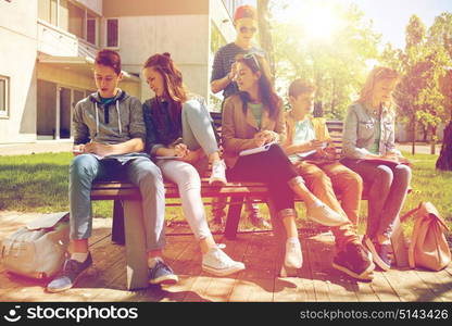 education, high school and people concept - group of happy teenage students with notebooks learning at campus yard. group of students with notebooks at school yard