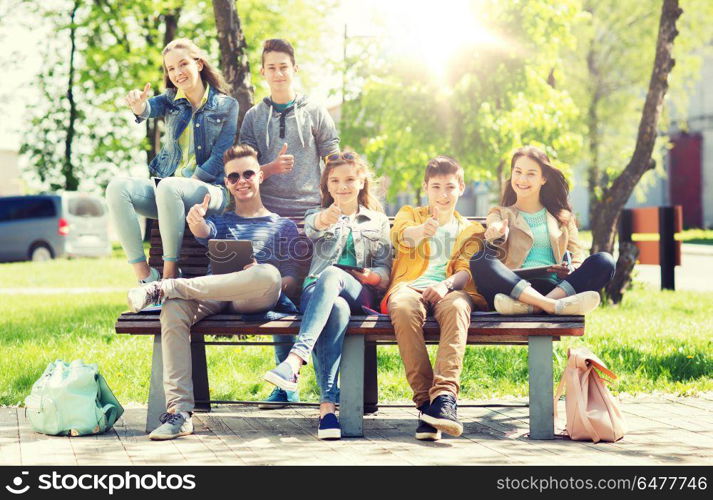 education, high school and people concept - group of happy teenage students with with tablet pc computers at campus yard. group of students with tablet pc at school yard. group of students with tablet pc at school yard