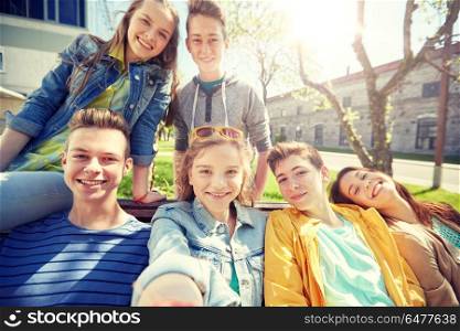 education, high school and people concept - group of happy teenage students or friends taking selfie. happy teenage students or friends taking selfie. happy teenage students or friends taking selfie