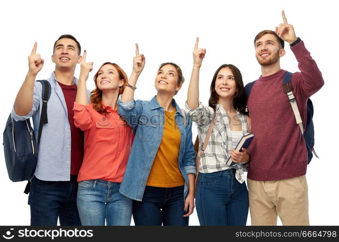 education, high school and people concept - group of smiling students pointing fingers up over white background. group of happy students pointing fingers up