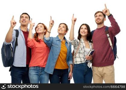 education, high school and people concept - group of smiling students pointing fingers up over white background. group of happy students pointing fingers up