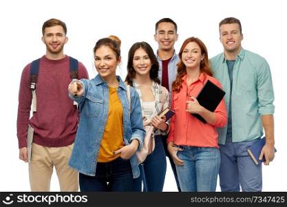 education, high school and people concept - group of smiling students with books and bags pointing at you over white background. group of students with books and school bags