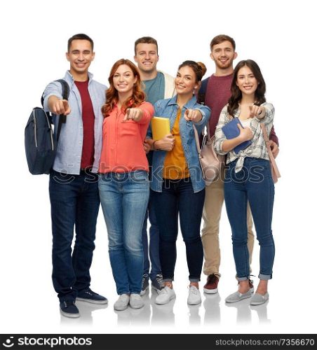 education, high school and people concept - group of smiling students with books and bags pointing at you over white background. group of students with books and school bags