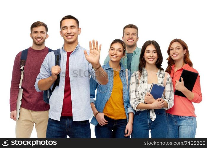 education, high school and people concept - group of smiling students with books waving hands over white background. group of students with books and school bags