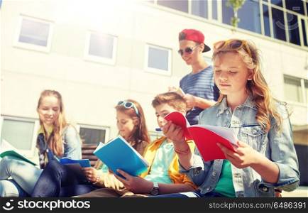 education, high school and people concept - group of teenage students with notebooks learning at campus yard. group of students with notebooks at school yard. group of students with notebooks at school yard