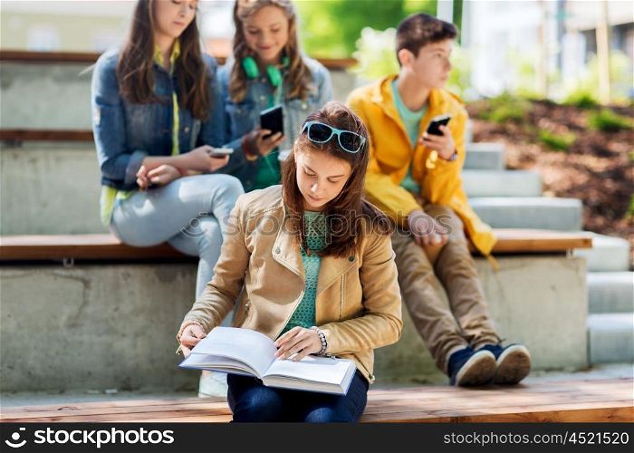 education, high school and people concept - high school student girl reading book outdoors