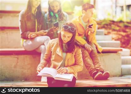 education, high school and people concept - high school student girl reading book outdoors. high school student girl reading book outdoors