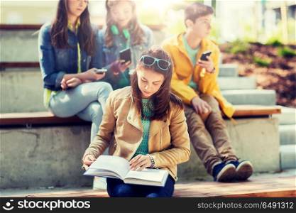 education, high school and people concept - high school student girl reading book outdoors. high school student girl reading book outdoors. high school student girl reading book outdoors