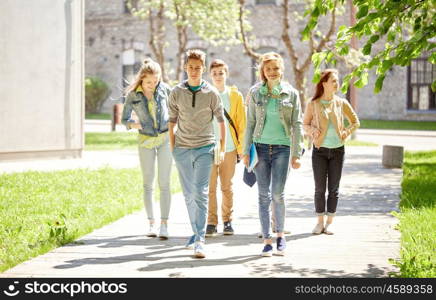 education, high school, communication and people concept - group of happy teenage students walking outdoors