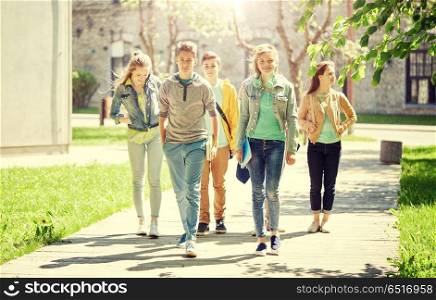 education, high school, communication and people concept - group of happy teenage students walking outdoors. group of happy teenage students walking outdoors. group of happy teenage students walking outdoors