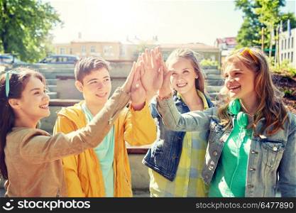 education, high school, friendship, gesture and people concept - group of happy teenage students or friends making high five outdoors. happy students or friends making high five. happy students or friends making high five