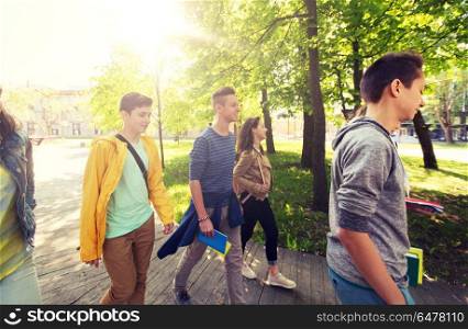education, high school, learning and people concept - group of happy teenage students walking outdoors. group of happy teenage students walking outdoors. group of happy teenage students walking outdoors