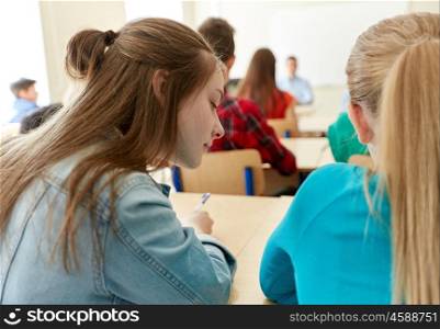education, high school, learning and people concept - group of students writing test