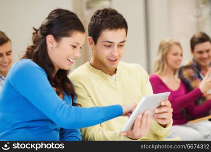 education, high school, teamwork and people concept - group of smiling students with tablet pc computers sitting in lecture hall