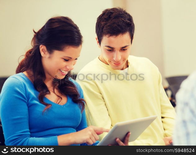 education, high school, teamwork and people concept - group of smiling students with tablet pc computers sitting in lecture hall