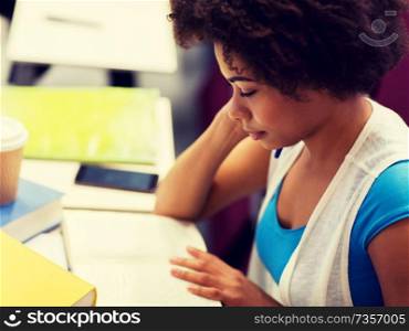 education, high school, university, learning and people concept - african student girl with books and coffee on lecture. student girl with books and coffee on lecture