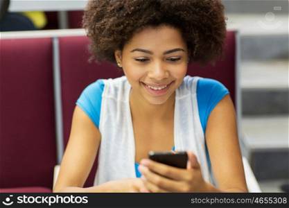 education, high school, university, learning and people concept - african student girl with smartphone on lecture