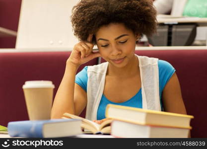 education, high school, university, learning and people concept - bored african student girl with books and coffee on lecture