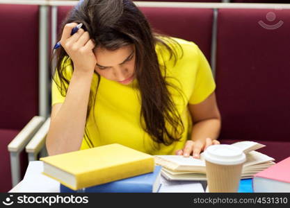 education, high school, university, learning and people concept - bored student girl with coffee reading book on lecture