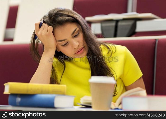 education, high school, university, learning and people concept - bored student girl with books and coffee on lecture