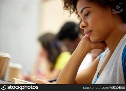 education, high school, university, learning and people concept - close up of african student girl on lecture