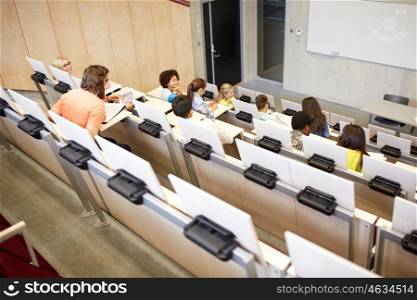 education, high school, university, learning and people concept - group of international students in lecture hall